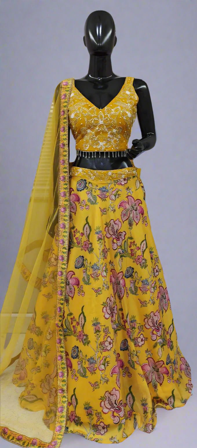 Yellow floral traditional outfit on a mannequin against a neutral background
