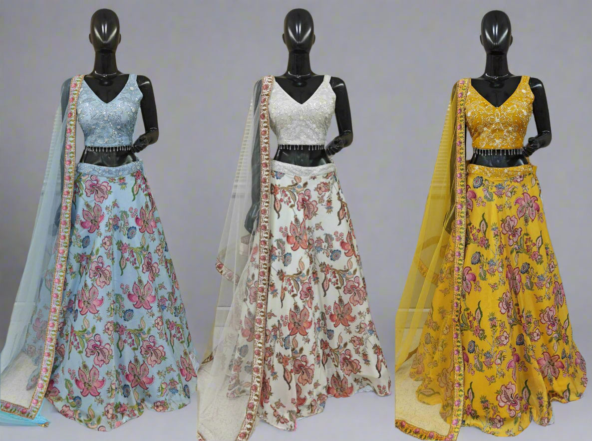 Three mannequins wearing floral dresses with dupattas against a neutral background